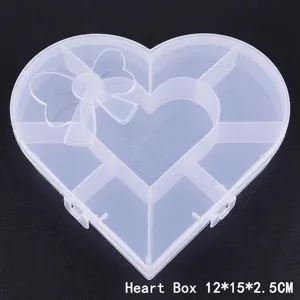 Dettaglio scatola porta gioielli trasparente a cuore con 7 scomparti, misura 12x15x2,5cm