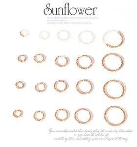 Textured iron jump rings for DIY jewelry making in various sizes shown on white background