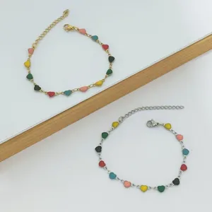 Detailed view showing a gold and silver stainless steel bracelet with colorful heart charms