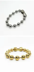 Detailed macro view of titanium steel ball chain bracelets in gold and silver finishes.