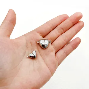 Stainless steel heart magnetic clasps for jewelry making in two sizes held in palm