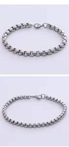 Detailed view of silver box chain bracelet with lobster clasp and metallic luster