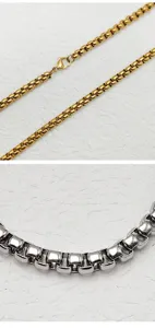 Detailed macro view showing silver and gold stainless steel box chain necklace textures