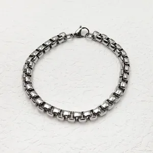 Minimalist silver stainless steel box chain bracelet for men and women on white background