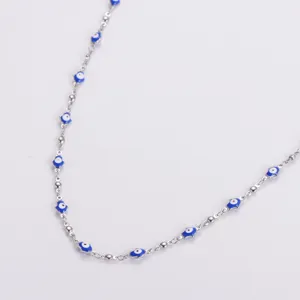 Detail view of a premium stainless steel necklace with blue Hamsa hand evil eye charms