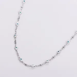 Detailed view of the stainless steel Hamsa hand evil eye charms on a silver beaded chain
