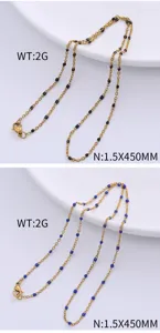 Close-up detail of black and blue enamel beads on gold-plated stainless steel chain