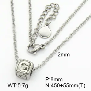 Macro view showing the engraved letter G cube pendant on a silver stainless steel chain