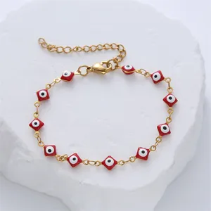 Close-up of Turkish Evil Eye stainless steel bracelet with red diamond oil drip charms