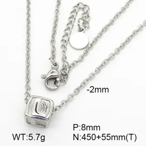 Close-up of titanium steel necklace with an engraved letter L cube pendant detail