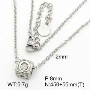 Detail view of titanium steel cube pendant with engraved letter Q on a silver chain.