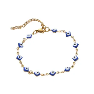 Gold stainless steel Evil Eye bracelet with blue enamel charms on white background