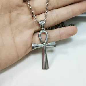Close-up detail of a silver-tone stainless steel Ankh cross pendant on a link chain.