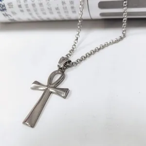 Detail of a retro stainless steel Ankh cross necklace pendant in silver finish.