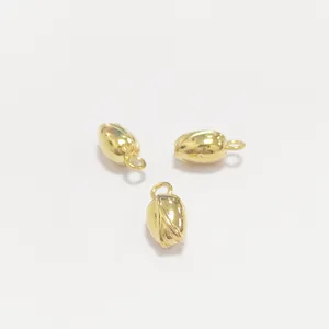 Macro detail of three golden stainless steel lotus seed charms for DIY jewelry making