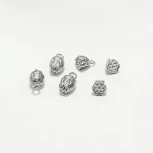 Detailed view of silver stainless steel lotus pod and flower charms for DIY jewelry