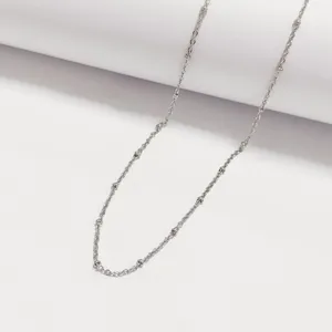 High-quality detail view of a silver stainless steel ball-station chain necklace design