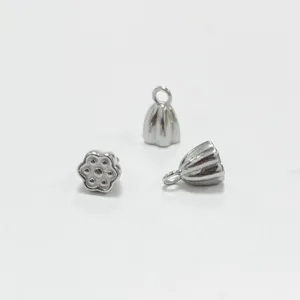 Detailed view of polished stainless steel lotus seed pod charms for DIY jewelry