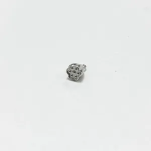 Close-up detail of a small stainless steel lotus pod pendant for DIY jewelry making