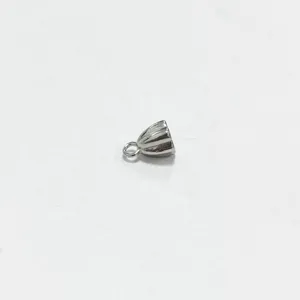 Macro detail of a small silver stainless steel lotus pod pendant for jewelry making