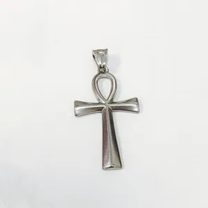 Close-up of a vintage stainless steel Ankh cross pendant with a polished silver finish.