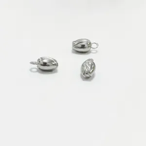 Macro view of stainless steel lotus pod seed charms with polished silver finish for DIY