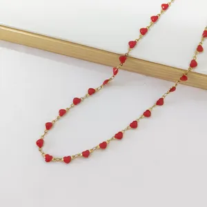 Close-up of a gold stainless steel chain necklace with multiple red enamel hearts