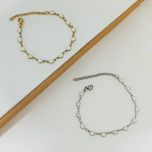 Detailed view of heart-shaped stainless steel bracelets with white enamel oil drip finish