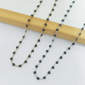 Detail view of stainless steel heart enamel necklaces in gold and silver finishes.
