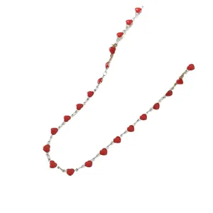 Minimalist stainless steel necklace featuring vibrant red enamel hearts for women.