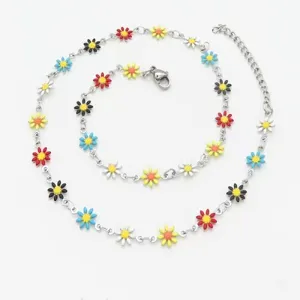 Close-up detail of a stainless steel chain necklace featuring colorful enamel daisy charms