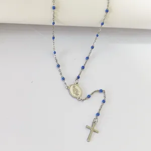 Detail view of a stainless steel religious rosary necklace with blue oil drip beads.