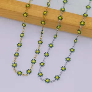 Detailed view of three stainless steel daisy necklaces in gold and silver metal finishes
