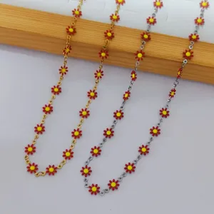 Detail view of colorful enamel daisy necklaces with gold and silver-tone chains.