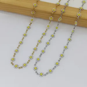 Close-up detail of stainless steel daisy necklaces featuring white petals and yellow centers