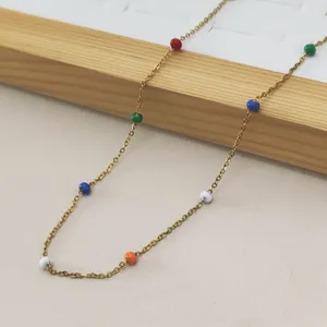Close-up of a stainless steel necklace featuring vibrant candy-colored rainbow enamel beads.