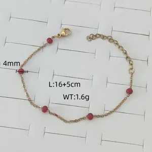 Detail view of a gold stainless steel bracelet with 4mm red beads and size dimensions.