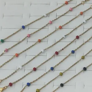 Detailed view of colorful enamel bead gold-toned stainless steel chain bracelets