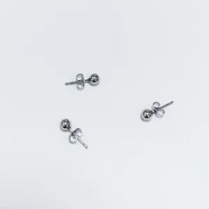 Detailansicht minimalistischer Edelstahl-Ohrstecker in Silberkugelform für Piercings