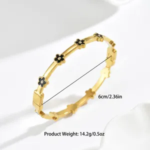 Elegante gouden armband met zwarte bloembedels en strass-steentjes voor dames
