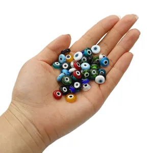 Handful of colorful flat round evil eye glass beads for DIY jewelry making and crafts