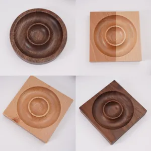Detailed view of square and round wooden bead trays in various natural wood tones