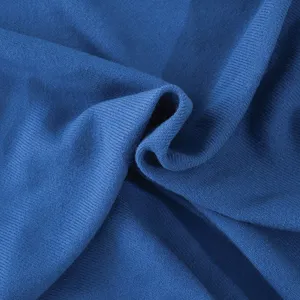 Close-up view of soft blue knitted multifunctional nap blanket with fine rib texture