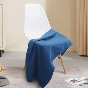 Blue soft fleece shawl blanket draped over a chair for cozy office nap or home sofa use.