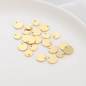 Macro detail of smooth 14K gold-plated copper round pendant tags for DIY jewelry