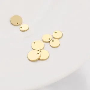 Close-up of polished 14K gold plated brass round disc pendants for DIY jewelry