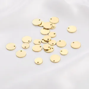 Macro detail of polished 14K gold plated brass blank round charms for DIY jewelry
