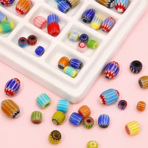 Detail view of colorful striped millefiori glass beads for DIY jewelry making.