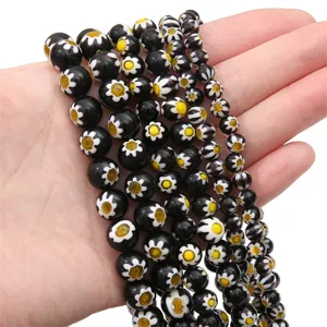 Strings of vintage black Millefiori glass flower beads for unique handmade DIY jewelry making.
