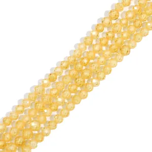 Detailed macro view of faceted yellow synthetic zircon crystal round beads for DIY jewelry